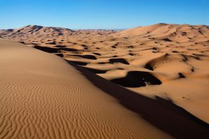 Sahara desert sand dunes with clear blue sky, Merzouga, Morocco.